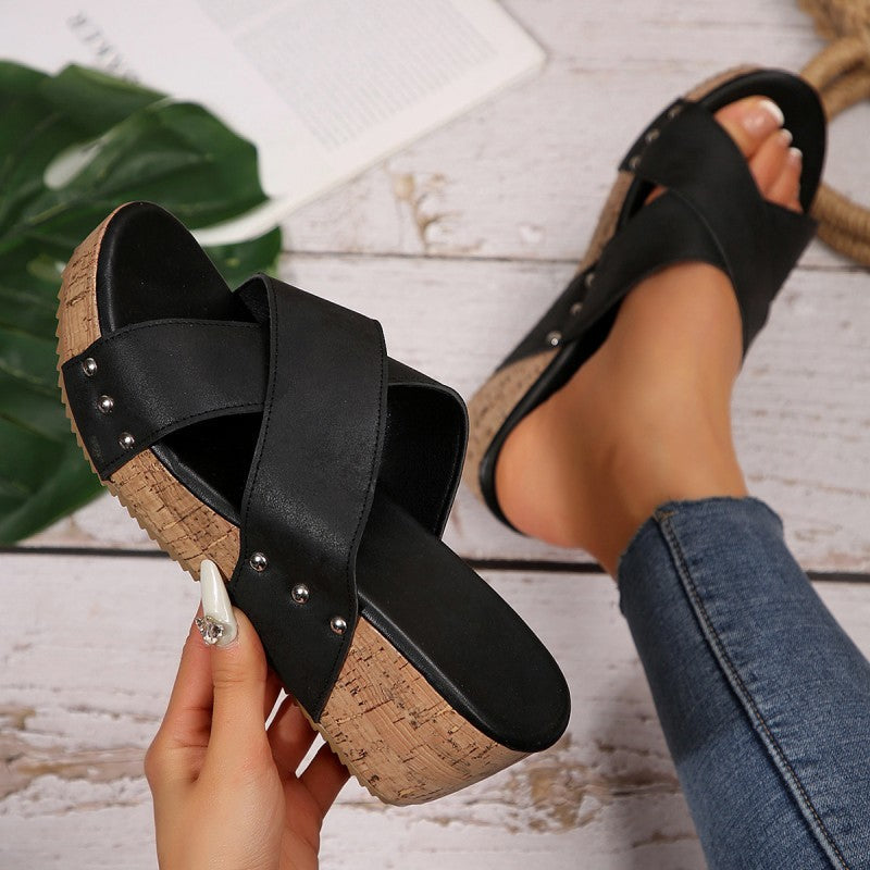 Black wedge sandals with wide cross straps, silver studs, cork-style platform sole