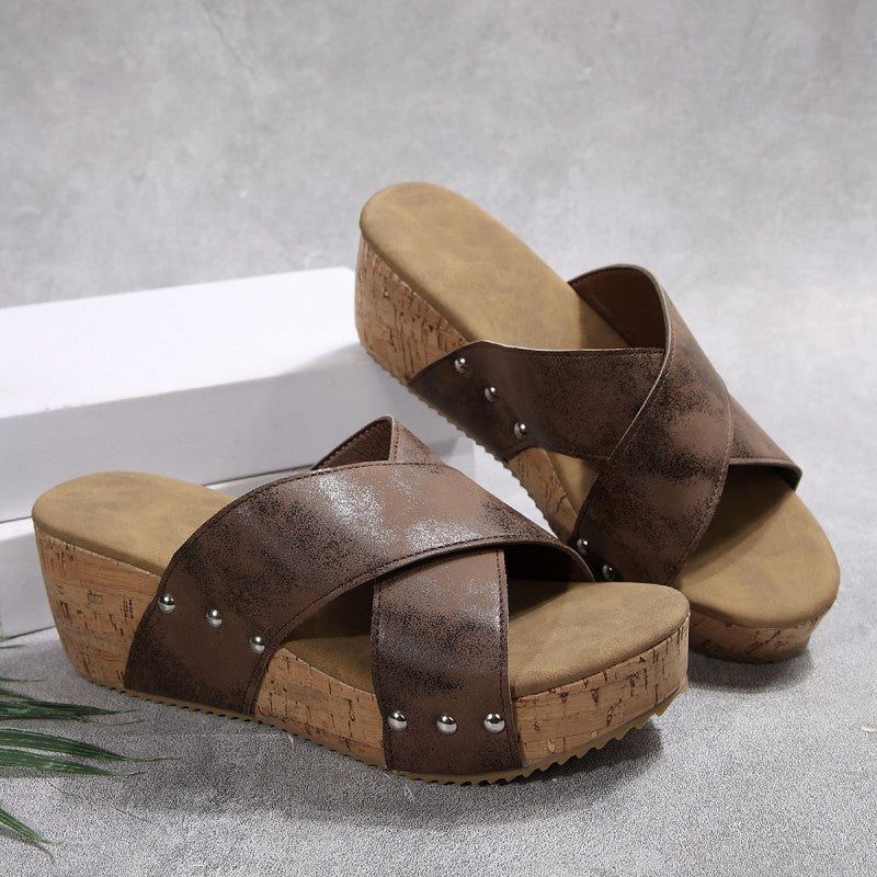 Brown wedge sandals with crisscross straps, silver studs, cork-style platform sole