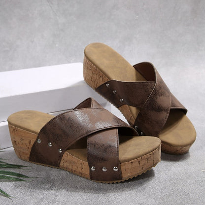 Brown wedge sandals with crisscross straps, silver studs, cork-style platform sole