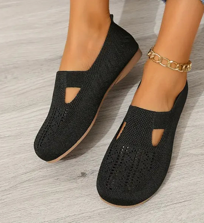 Black knit ergonomic sandals with side cutouts and low sole