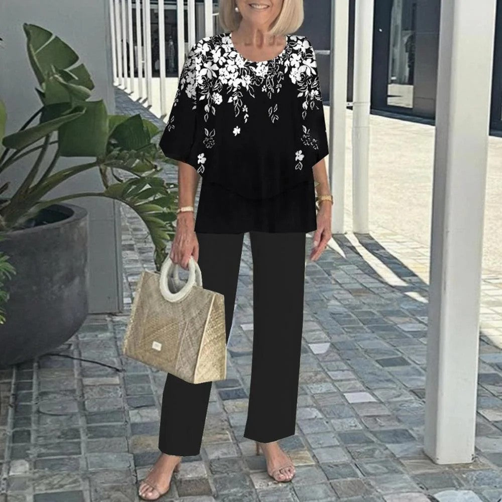 Black floral two-piece set with short-sleeve top and wide-leg solid black trousers
