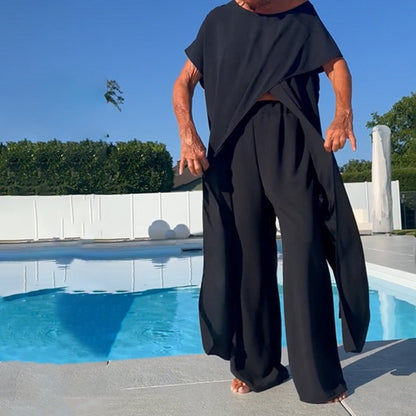 Two-piece set with off-shoulder black top and flowy wide-leg pants, loose drape