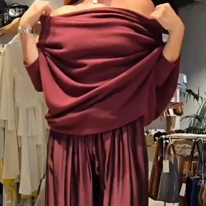 Off-shoulder dress set in deep red with flowing cowl top and pleated maxi skirt folds