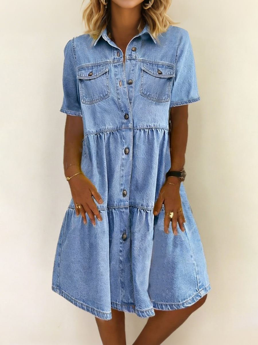 Light blue denim dress with short sleeves, button front, tiered skirt and chest pockets