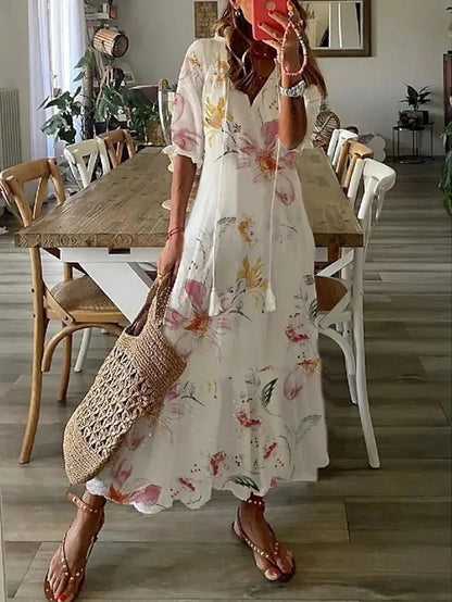 Loose bohemian dress in white with colorful wildflower print, tiered maxi skirt