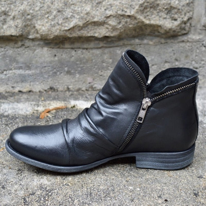 Black leather ankle boots with side zipper and low textured block heel