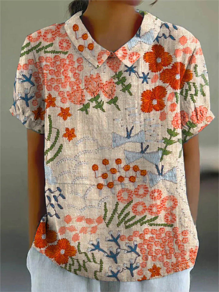 Rustic garden blouse with V-neck, short sleeves, and multicolor floral patchwork print